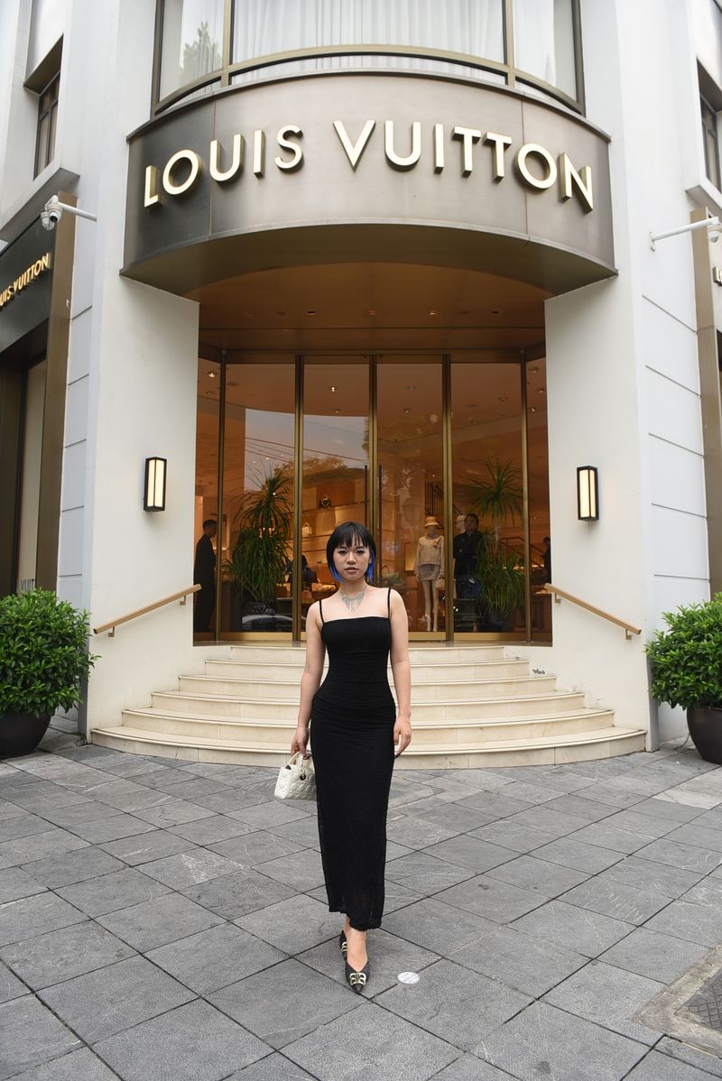 Woman in elegant black dress, boutique street style