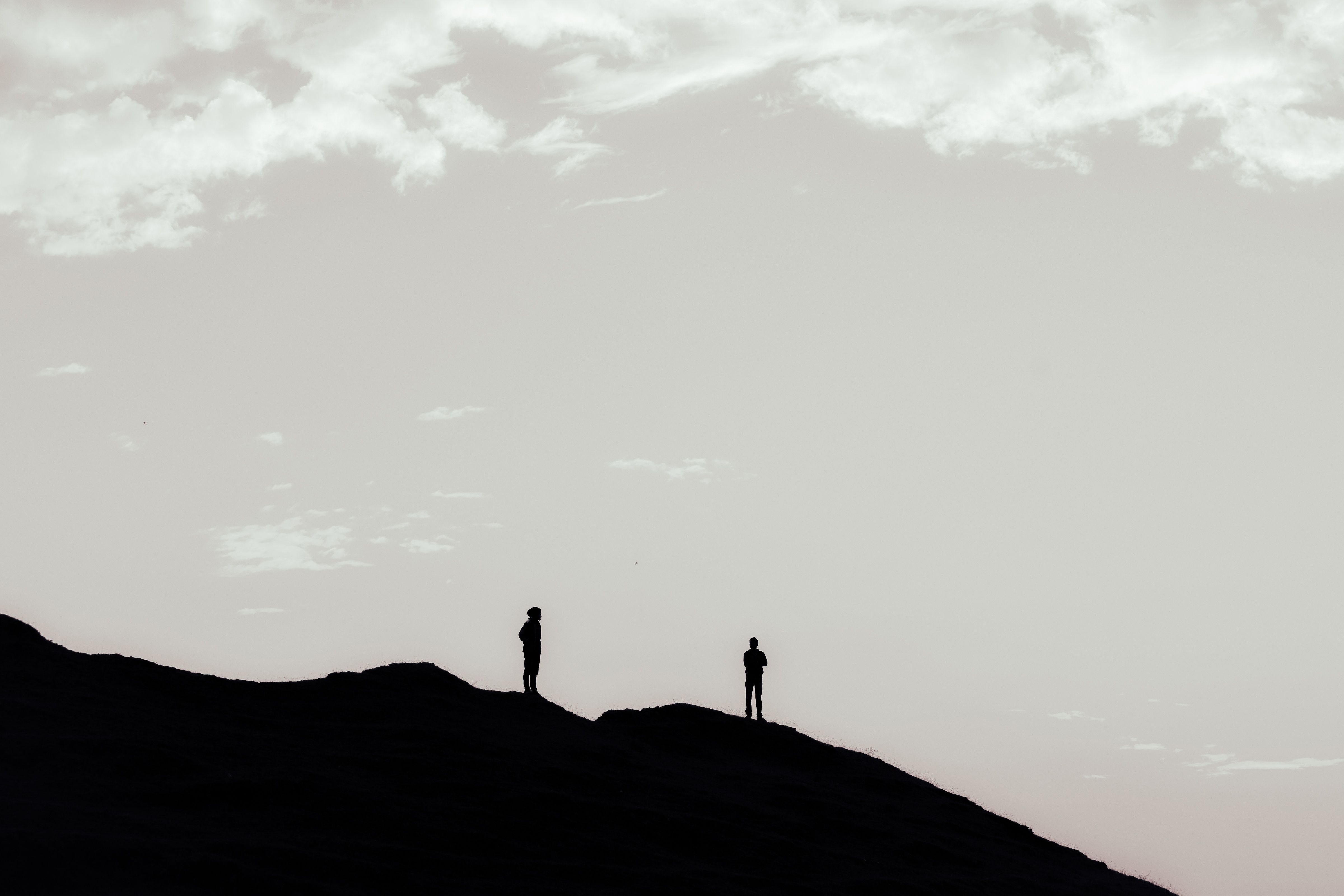 Silhouettes of Two People Standing on a Hill · Free Stock Photo
