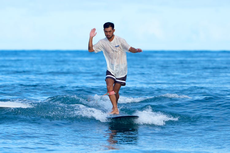 Tourist On A Surfboard In The Ocean