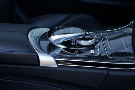 Close-up of a modern luxury car control console showcasing sleek design and technology.