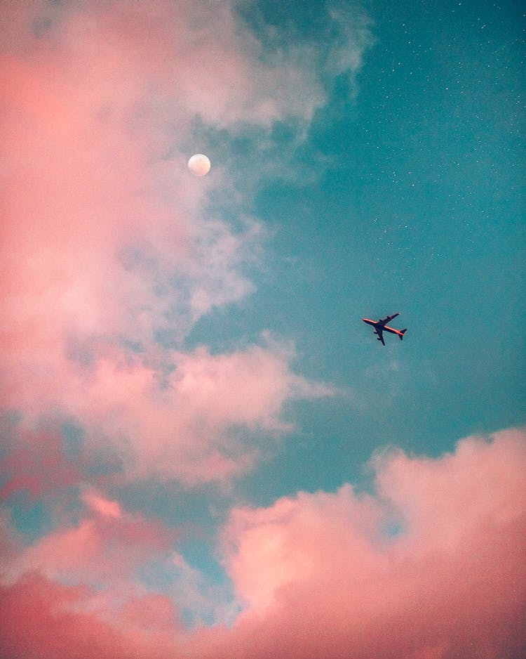 Airplane Flying Over The Clouds 