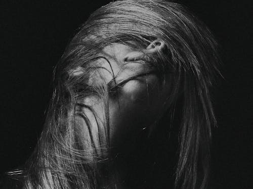 Grayscale Photography of Woman Flipping Her Hair