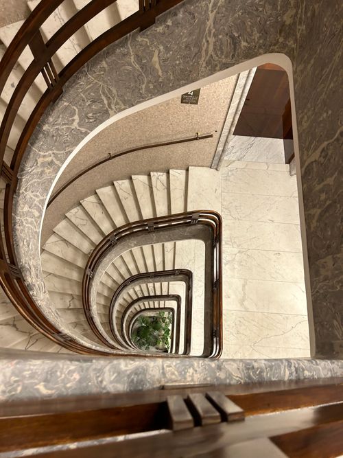 Free A breathtaking view from above of an elegant spiral staircase in a Roman building. Stock Photo