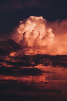 A stunning display of vibrant clouds at sunset, creating a moody and dramatic landscape.