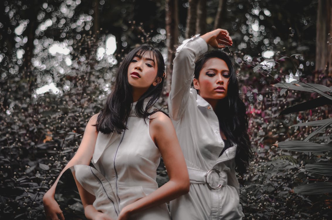 Photo of Two Women Standing Near Plants