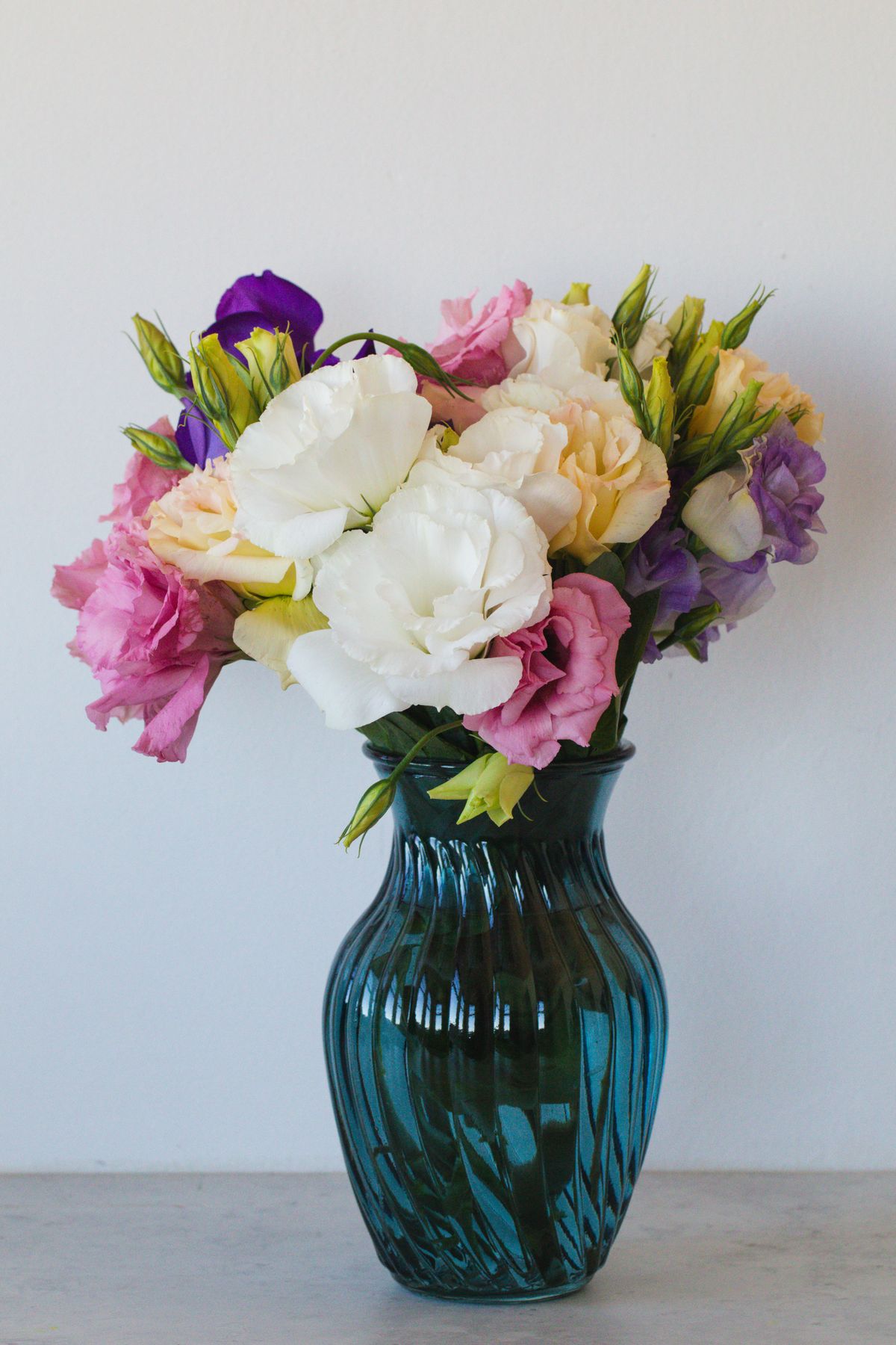 Pink gerbera flowers arranged in a small ceramic vase.