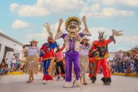 Colorful traditional festival parade in Rioja, Peru, featuring vibrant costumes and joyful participants.