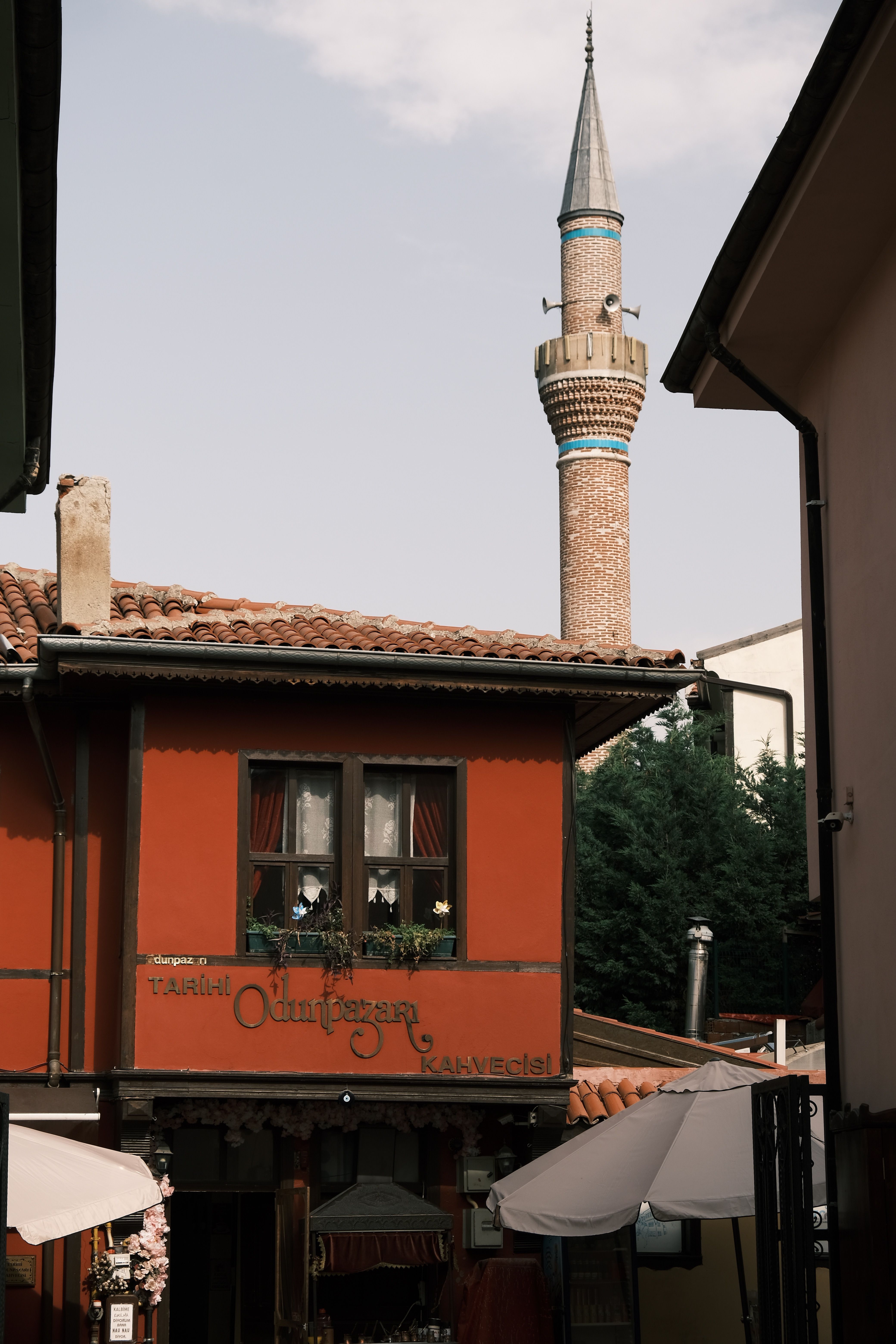Scenic view of a traditional village featuring a mosque minaret and classic architecture.