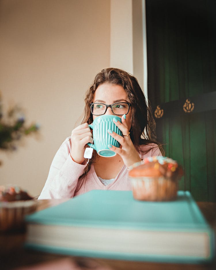 Woman Drinking On A Green Ceramic Mug