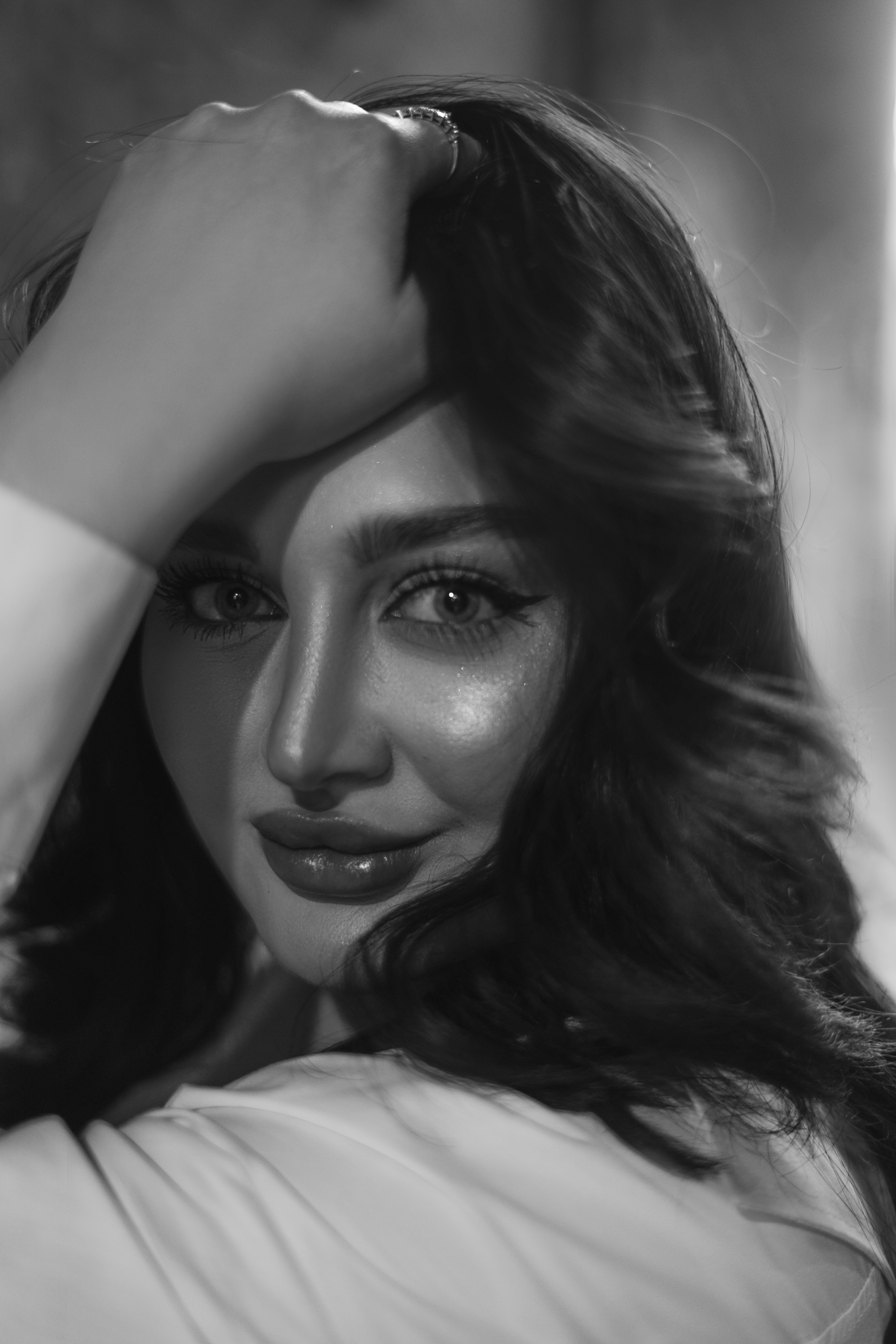 Close-up black and white portrait showcasing the elegance and beauty of a woman.