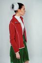 Woman in Red Zip Up Jacket and Green Skirt
