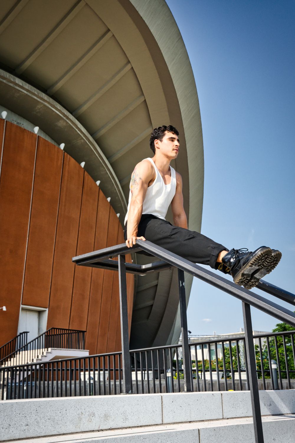 Handsome Model in White Tank Top Posing on Railing · Free Stock Photo