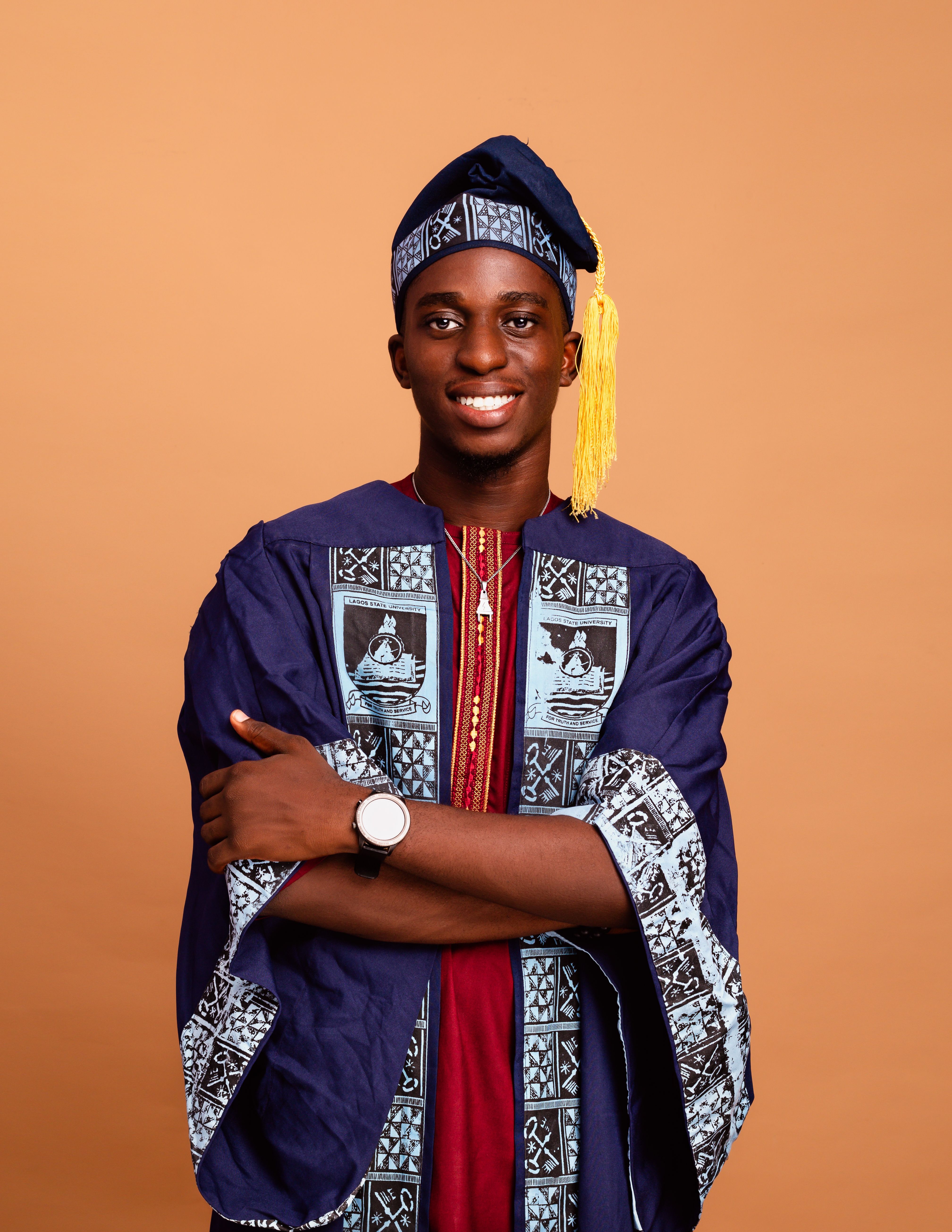 Happy Man in Traditional Graduation Cap and Gown  Free Stock Photo
