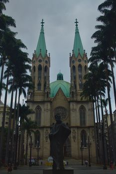 Exterior of São Paulo's iconic Metropolitan Cathedral surrounded by palm trees.
