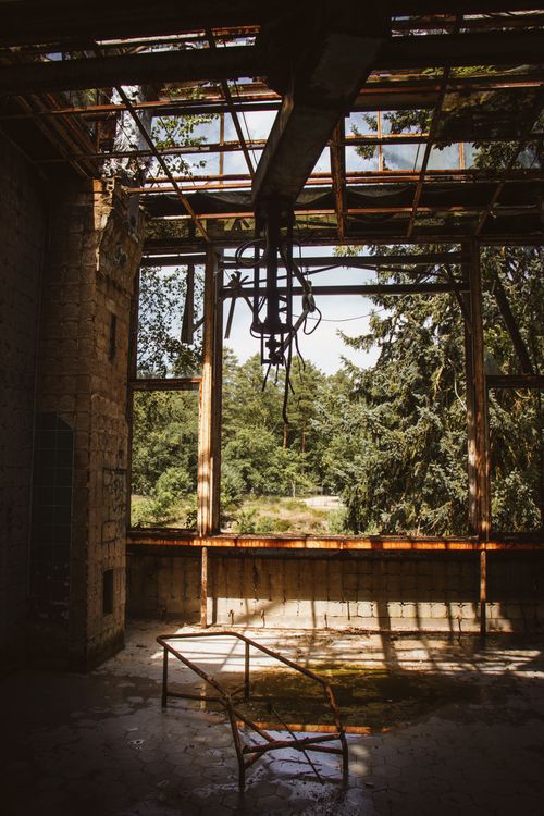 Free Interior of an abandoned industrial building in Beelitz showcasing decay and nature's encroachment. Stock Photo