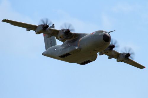 Free Aerial view of an A400M military transport aircraft flying through clear skies. Stock Photo