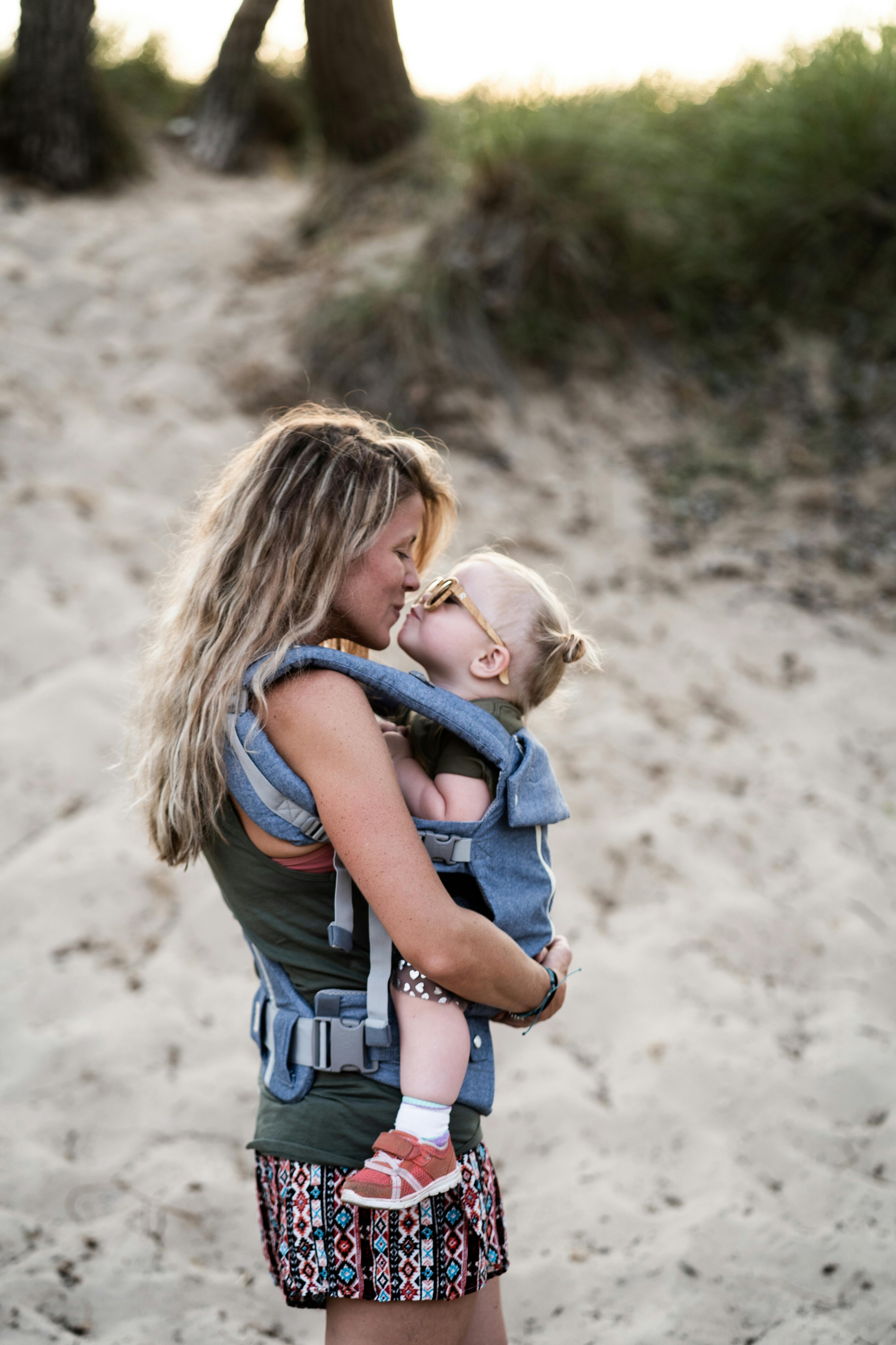 Woman Carrying Girl While Kissing