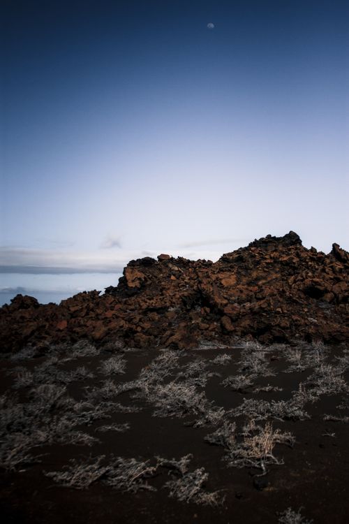 Free Capture of a rugged volcanic landscape under a serene moonlit sky. Stock Photo