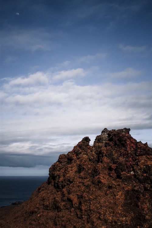 Free Volcanic peak under a dramatic sky on Bartolome Island, showcasing rugged natural beauty. Stock Photo
