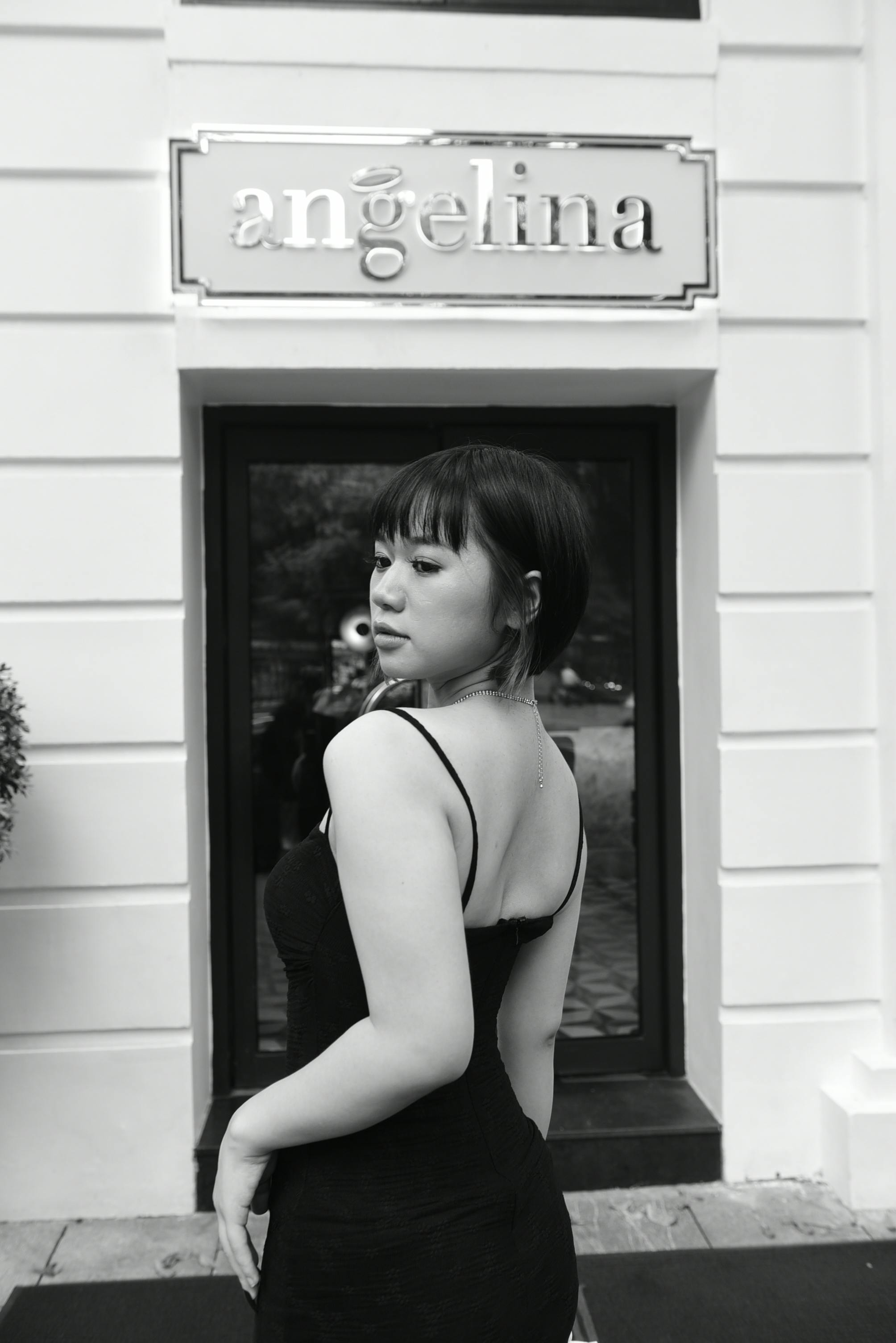 black and white photography of a young woman in an elegant dress