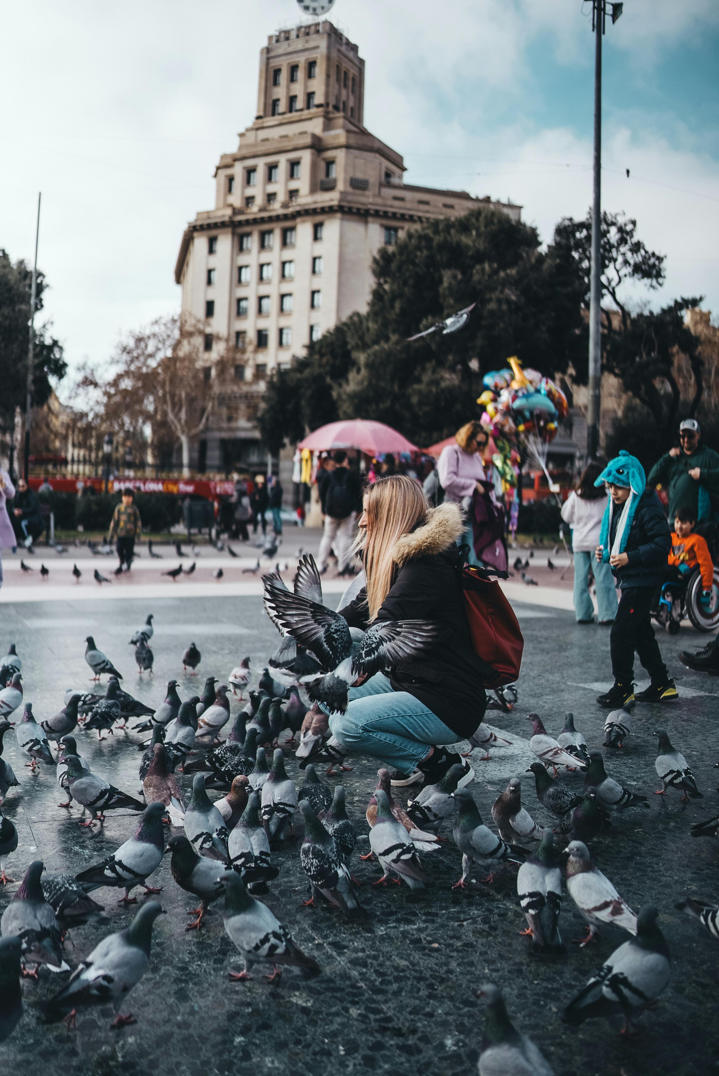 people and pigeons on a city square