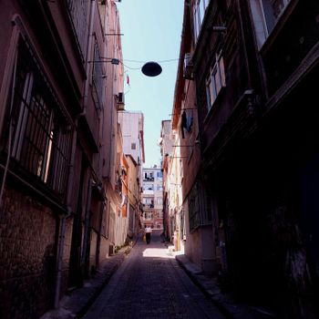 Discover the narrow residential streets of Istanbul with townhouses bathing in sunlight. Perfect for urban explorations.