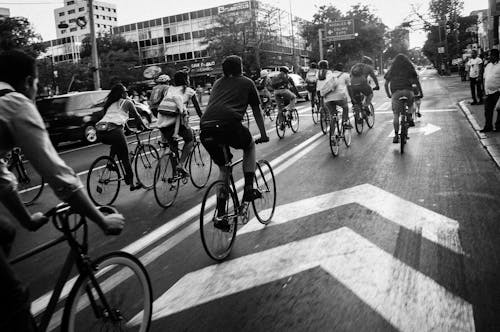 People Riding Bicycles on Street