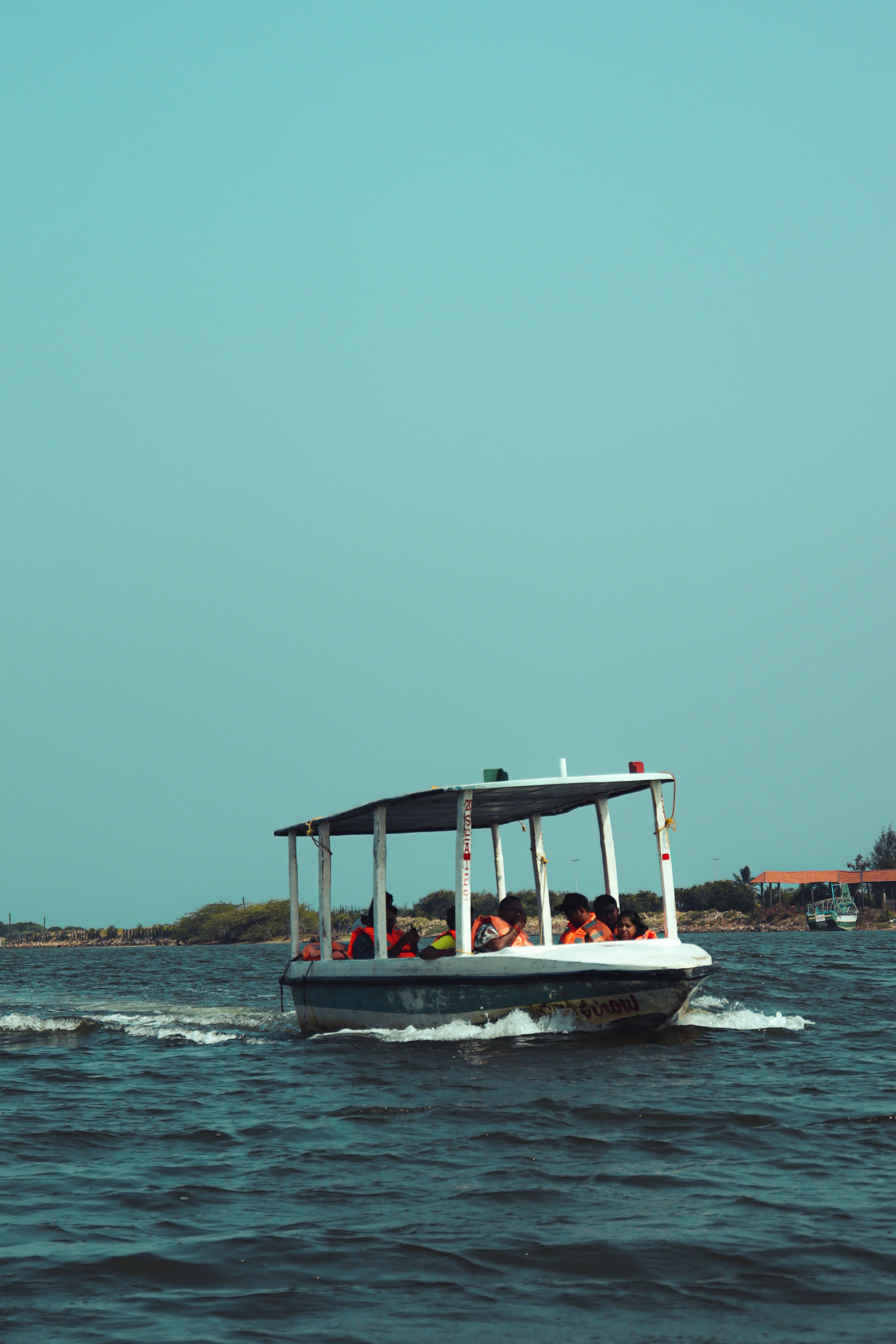 A boat with people on it in the water · Free Stock Photo