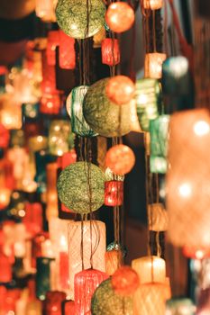Colorful hanging lanterns creating a festive illuminated ambiance with a variety of shapes and colors.