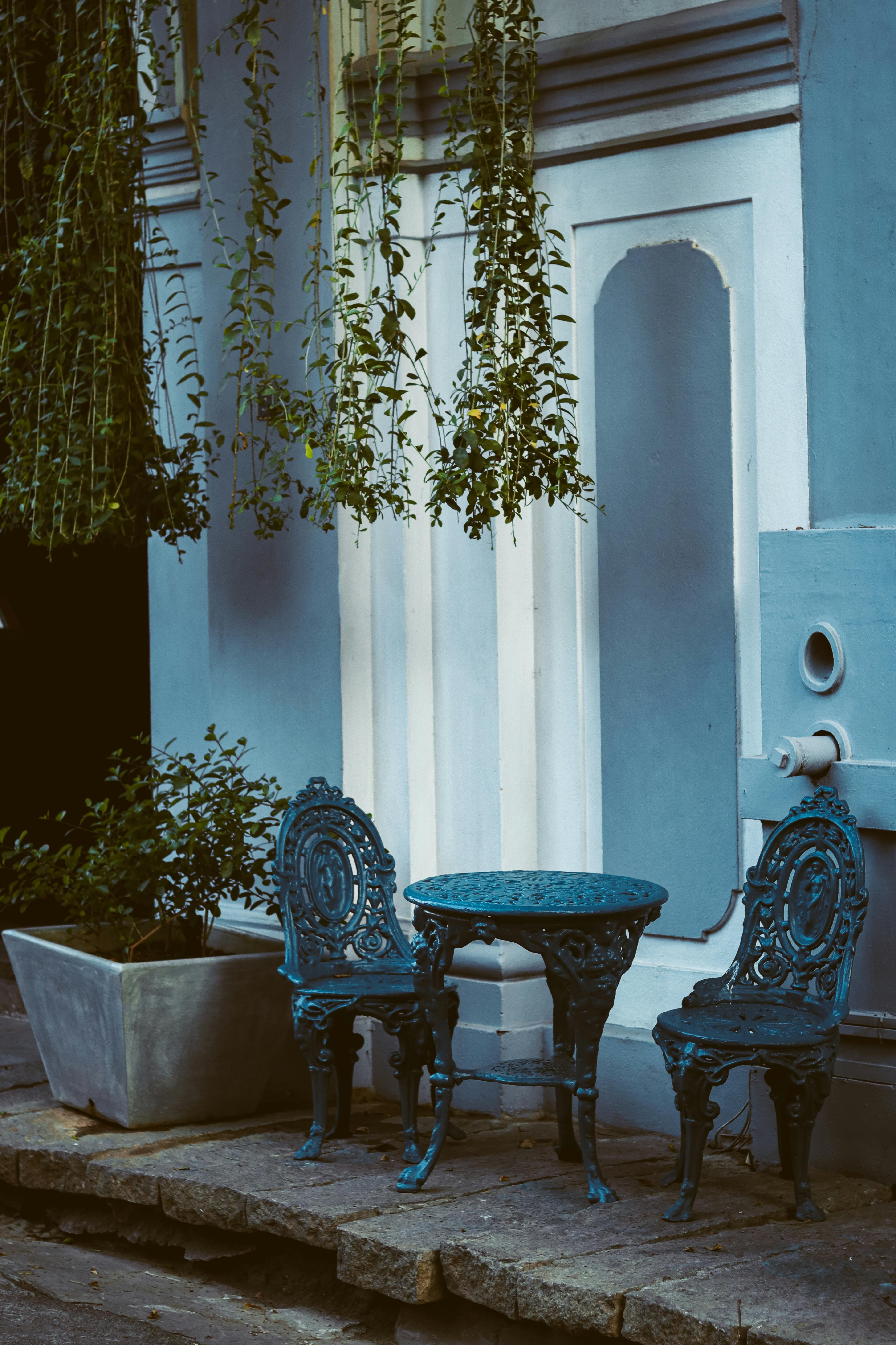 A blue table and chairs outside a building