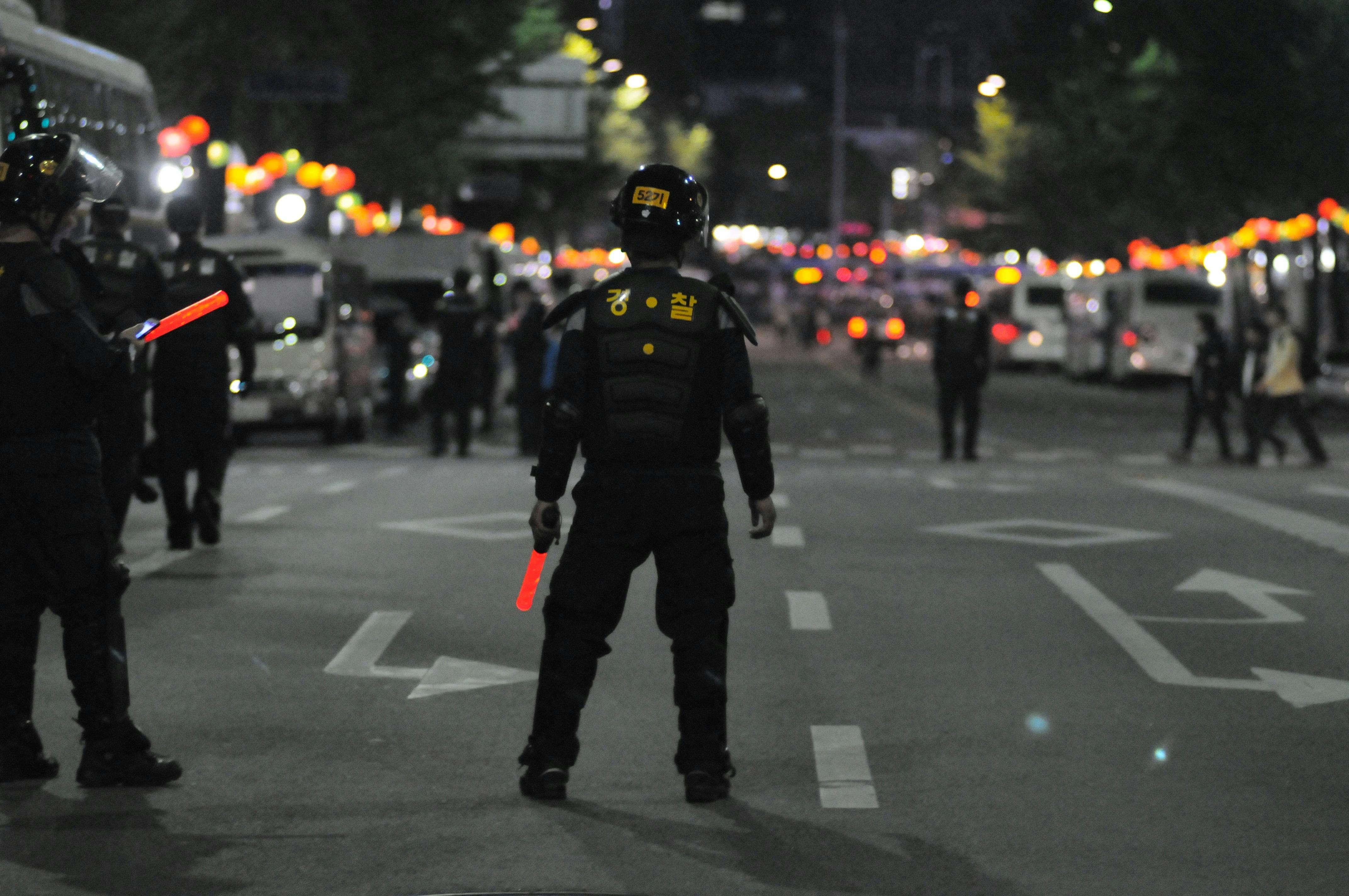 Police standing on asphalt during nighttime. | Photo: Pexels