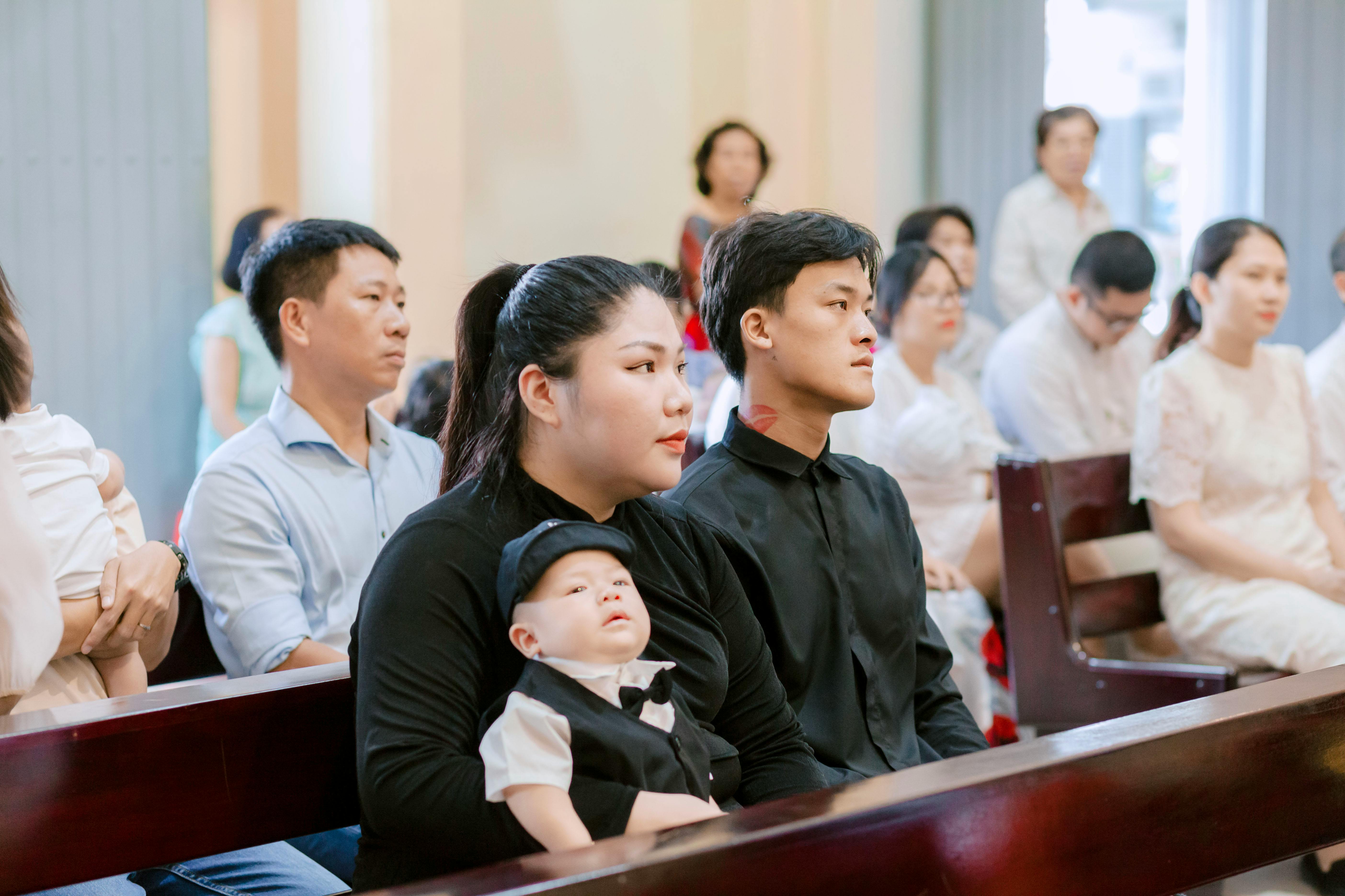 Family seated inside a church during a religious service, capturing a moment of togetherness.