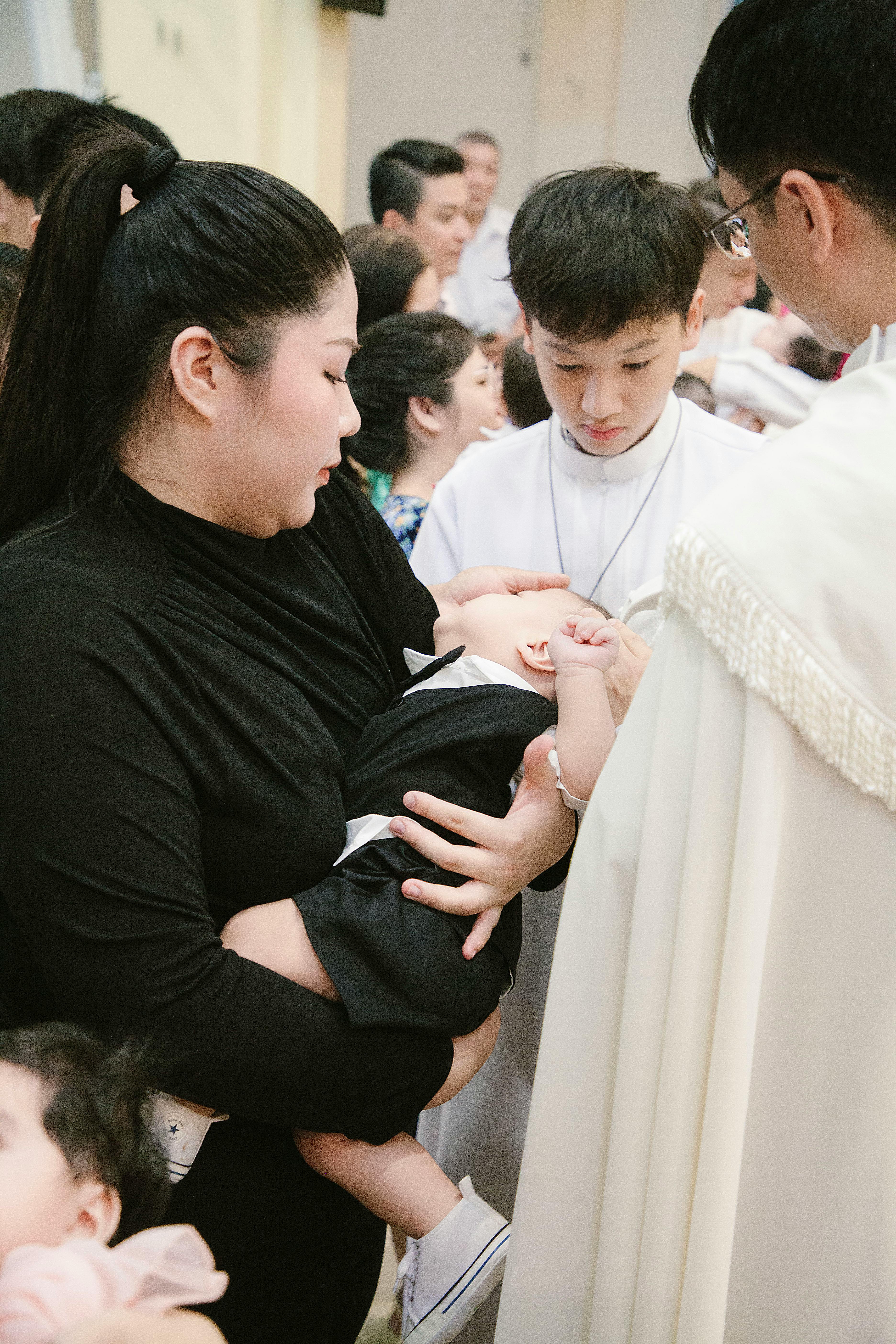 A woman holding a baby in a church