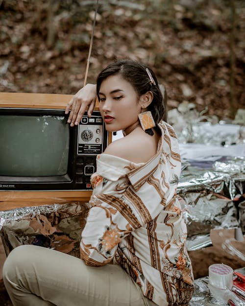 Woman Wearing White and Brown Shirt Beside Tv