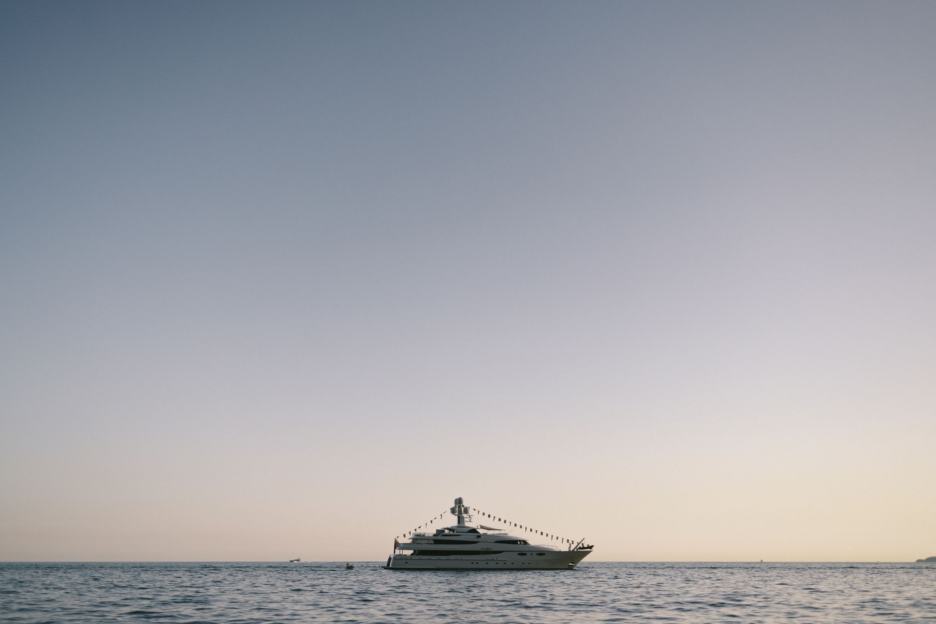Luxury yacht anchored off the Malibu coastline at golden hour