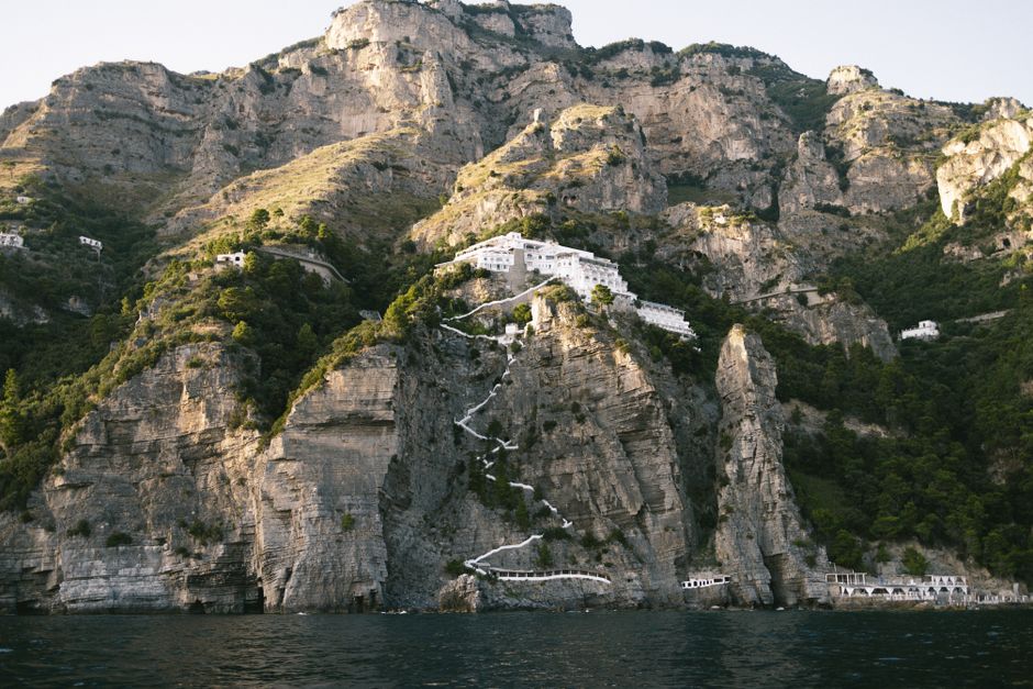 Breathtaking view of the rocky cliffs and Mediterranean sea along Positano's stunning Amalfi Coast.