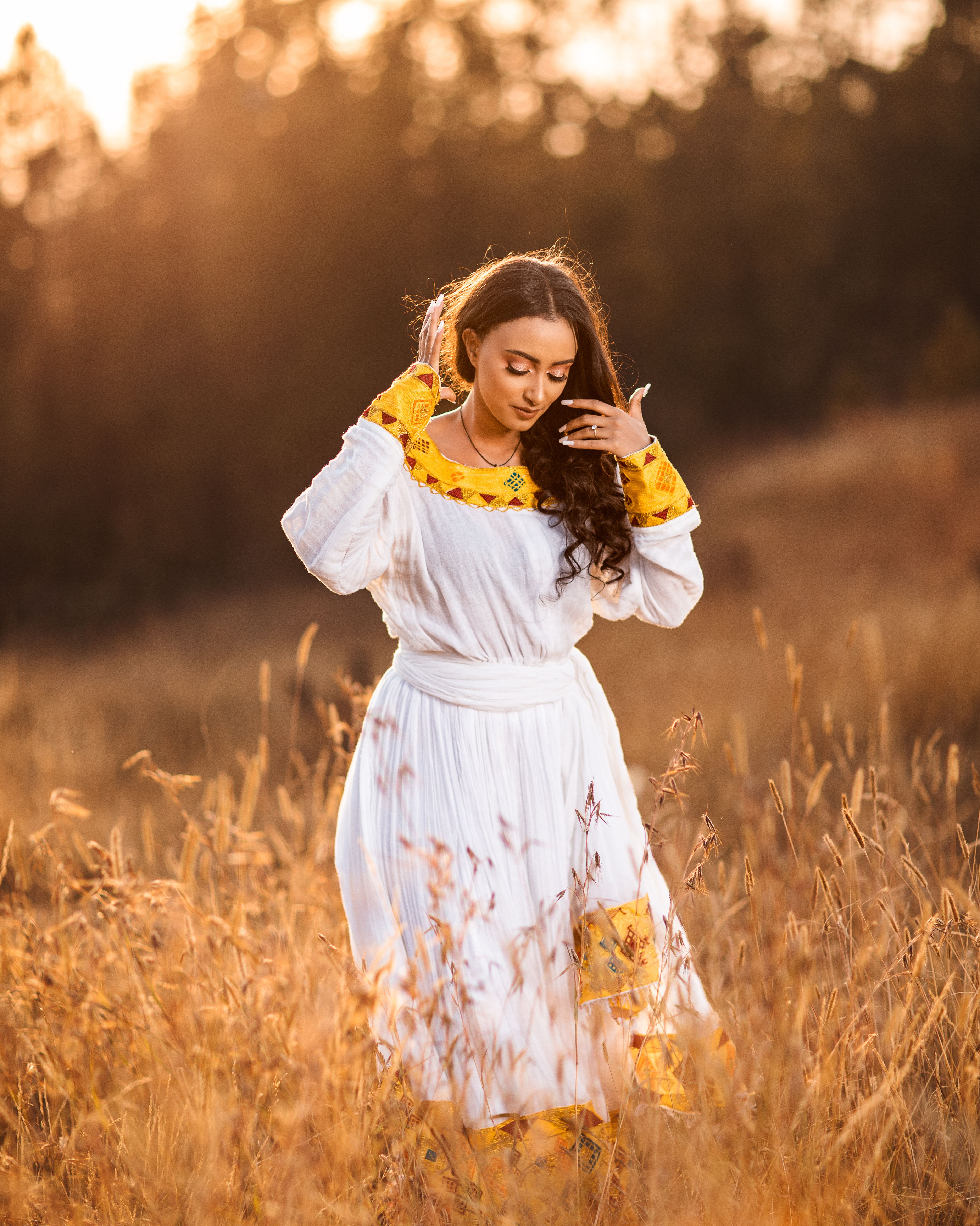 Woman in White Dress Standing in Field at Sunset · Free Stock Photo