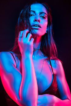 Artistic portrait of a woman with bold lighting in a fashion photoshoot.