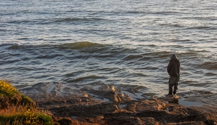 Fisherman Standing On Sea Shore