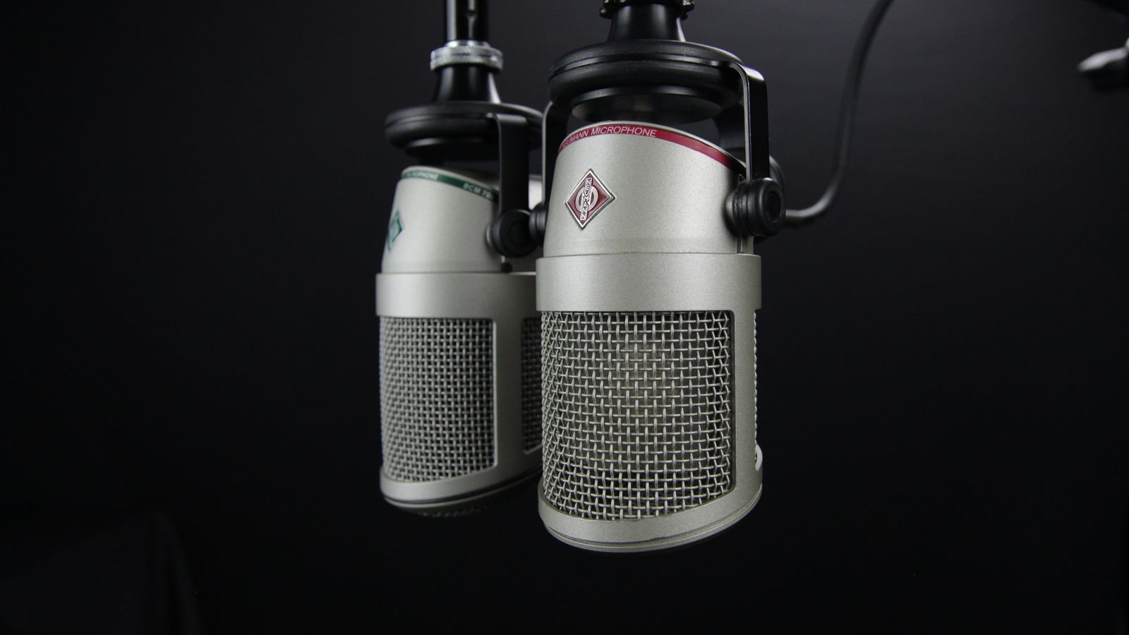 Close-up of two gray studio condenser microphones side by side in a recording studio, a real stock photo with no people in the frame, chosen because this story is about how an actress's Southern accent will sound as Rogue. It is not a still from the film and it does not show anyone from the cast