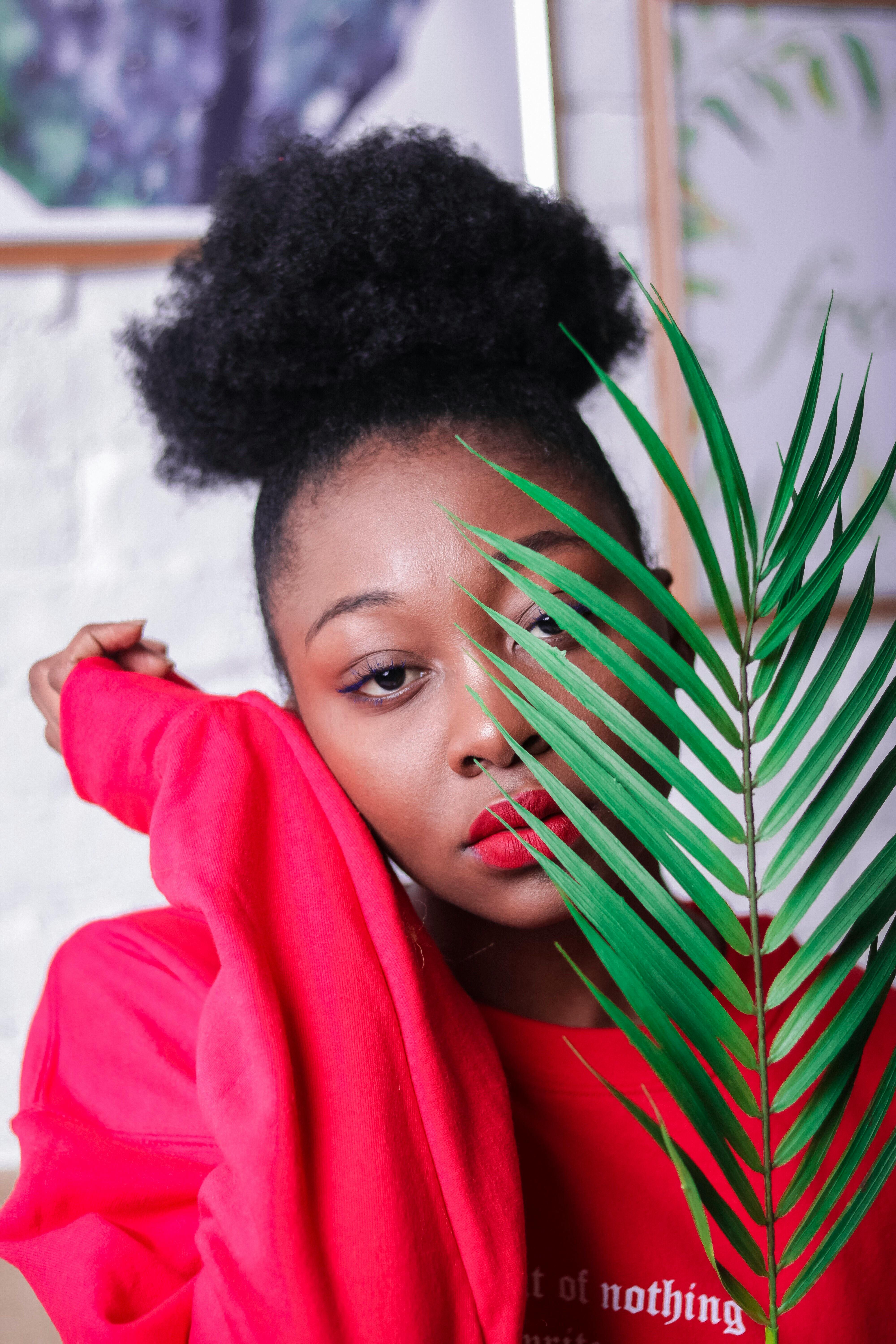 woman holding green leaves