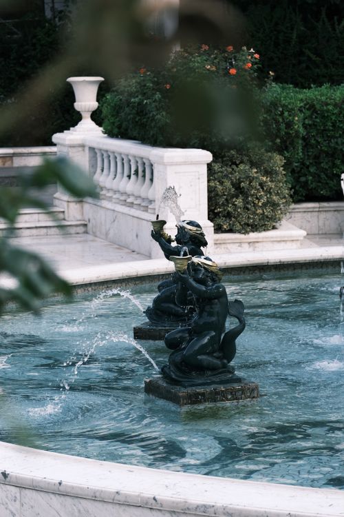 Free A beautiful garden fountain with intricate sculptures and water features. Stock Photo