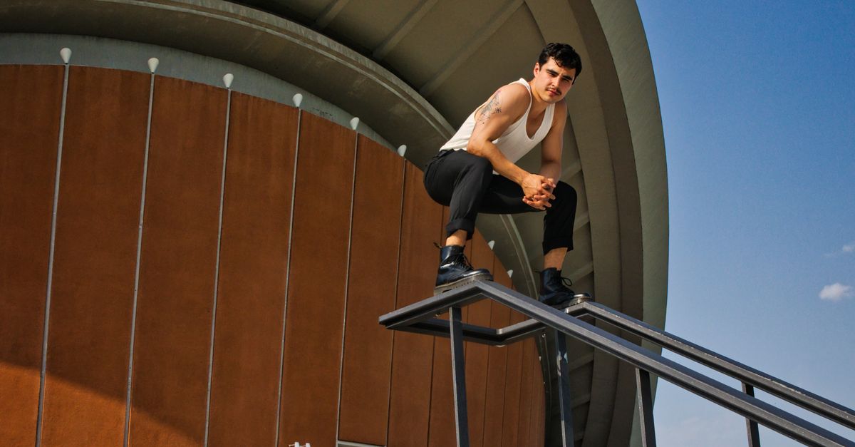 A Man Posing On A Handrail Free Stock Photo a-man-posing-on-a-handrail-free-stock-photo