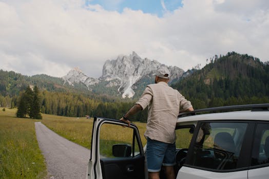 Man exits car to admire breathtaking Dolomites view, captured in Italian mountains.