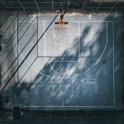 Aerial view of a concrete outdoor court with tree shadows, photo by Jakov Jovanoski on Pexels