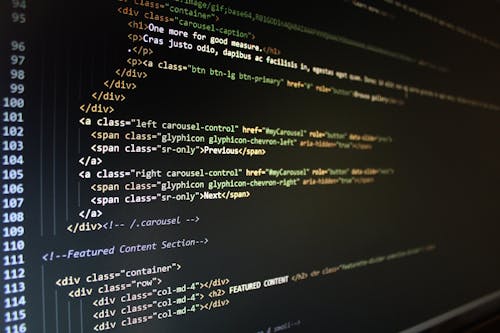 Free Close-up of HTML code displayed on a computer monitor, showcasing web development. Stock Photo