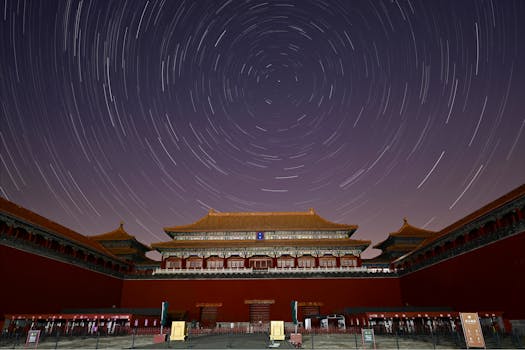 Stunning night view of the Forbidden City in Beijing with star trails across the sky.