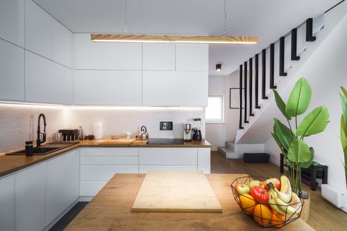 Free Contemporary Scandinavian kitchen with wooden countertops and house plants. Stock Photo