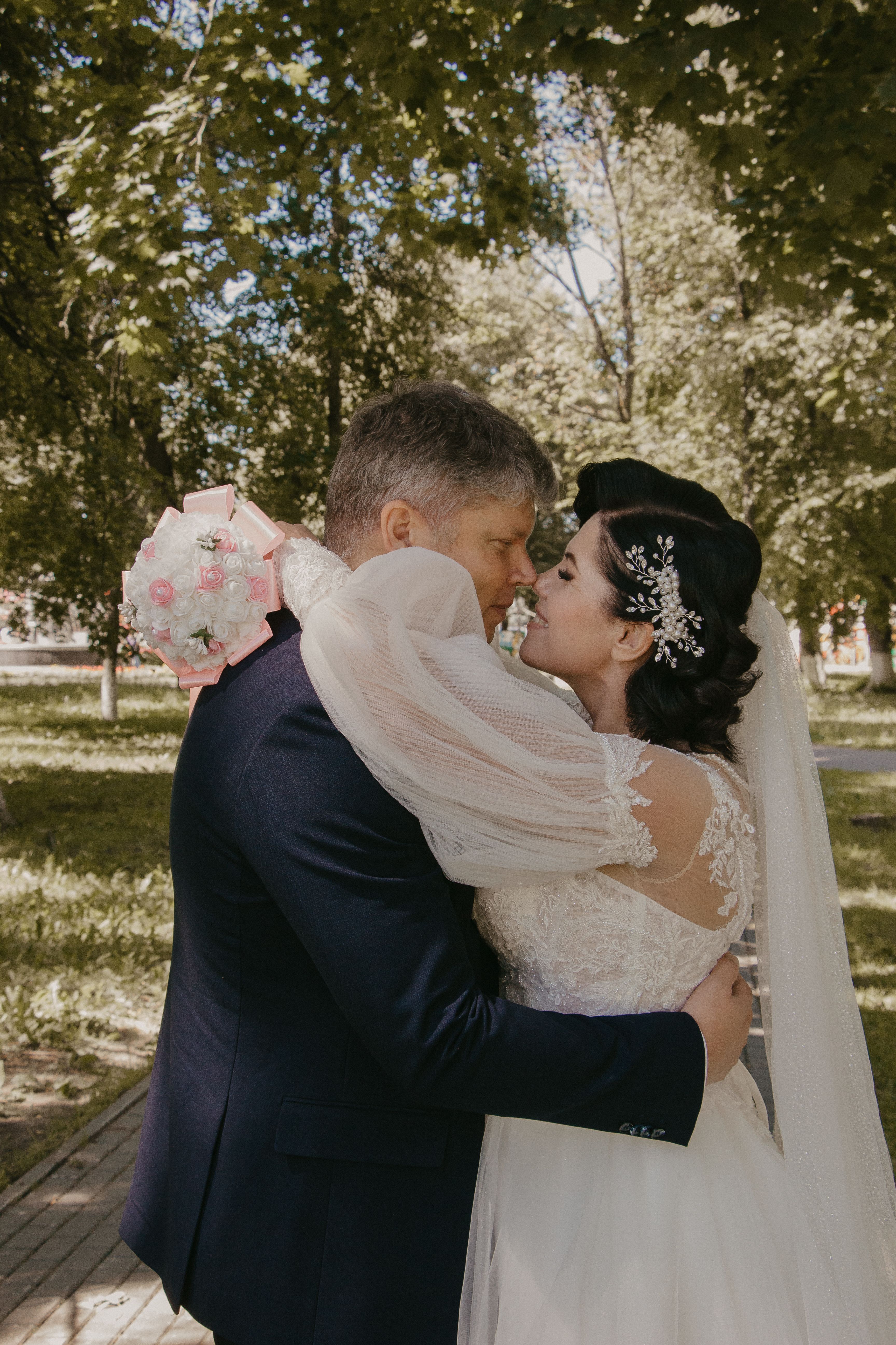 Groom and Bride Embracing in Park · Free Stock Photo