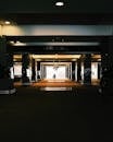 Silhouette of Person Walking through Underground Garage